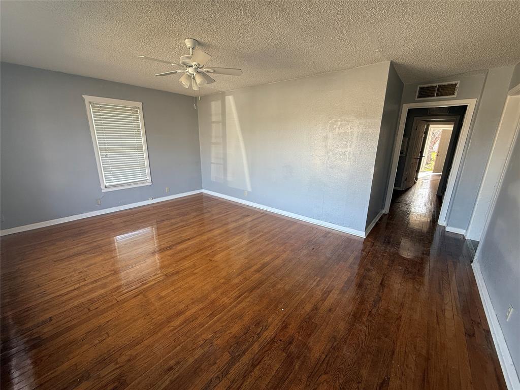 501 Needham Street Coleman, TX 76834 - Photo 16 of 16 a view of an empty room with wooden floor and a window