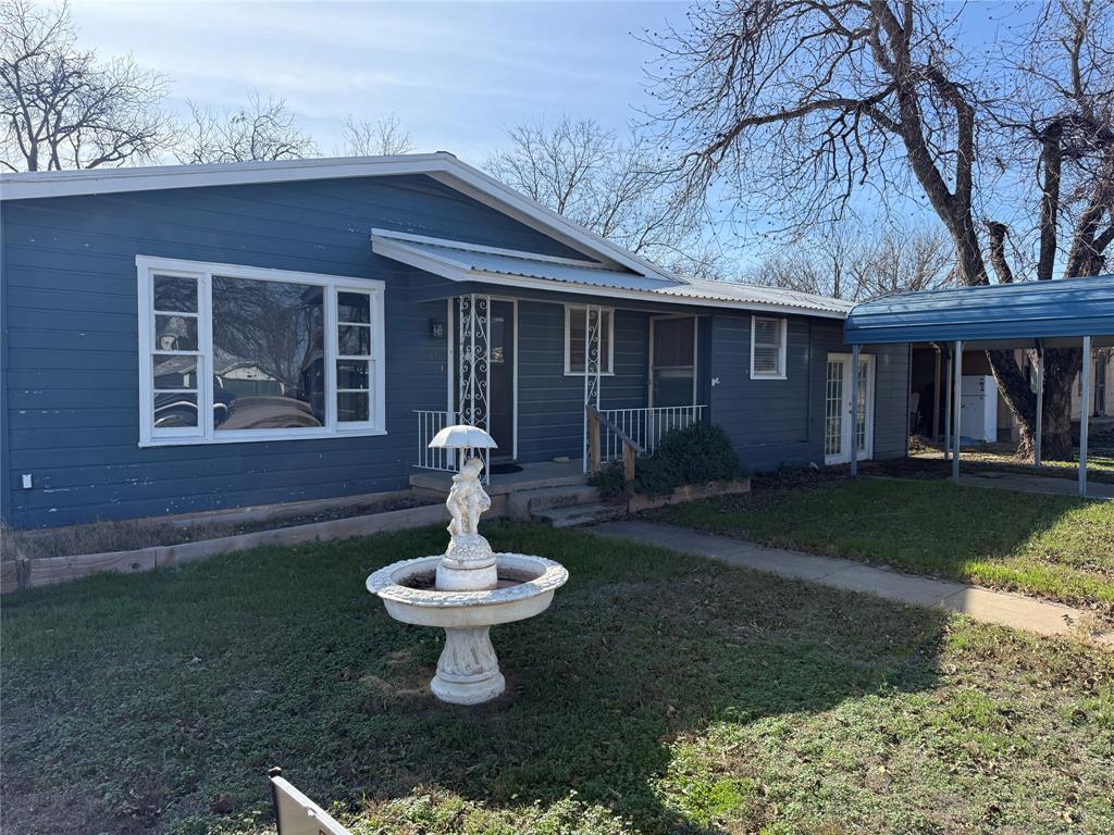 501 Needham Street Coleman, TX 76834 - Photo 2 of 16 a front view of a house with a yard and trees