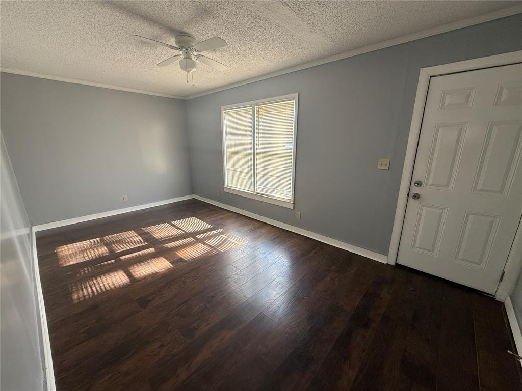 501 Needham Street Coleman, TX 76834 - Photo 10 of 16 a view of empty room with wooden floor and fan