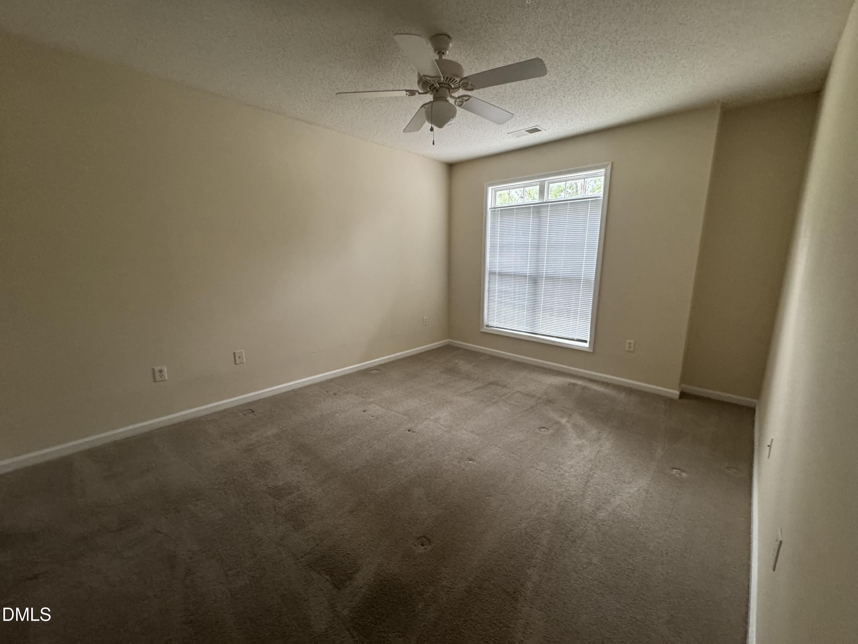 2510 Friedland Place, Unit 202 Raleigh, NC 27617 - Photo 19 of 25 an empty room with a ceiling fan and a window