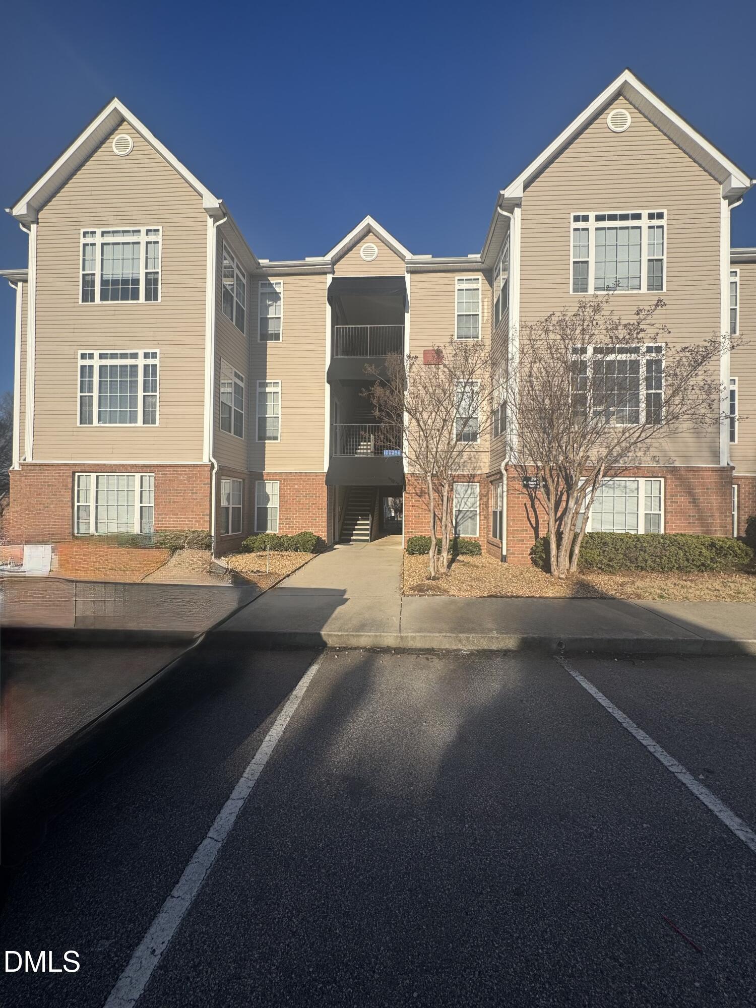 2510 Friedland Place, Unit 202 Raleigh, NC 27617 - Photo 2 of 25 a front view of a house with a yard