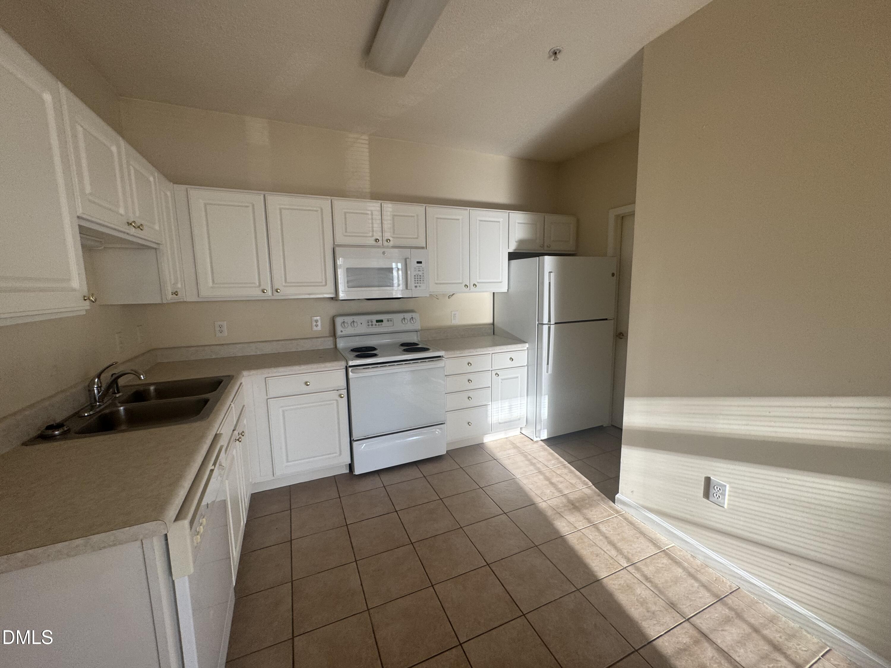 2510 Friedland Place, Unit 202 Raleigh, NC 27617 - Photo 6 of 25 a kitchen with a sink a stove and cabinets