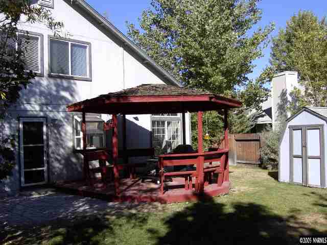 6302 Walnut Creek Road Reno, NV 89523 - Photo 7 of 8 a backyard of a house with barbeque oven table and chairs