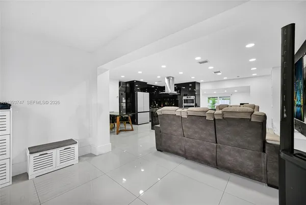 a bedroom with a bed and a television