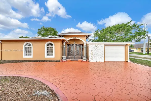 a living room with furniture kitchen view and a chandelier