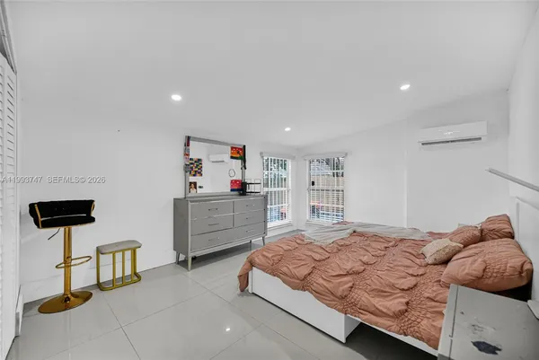 an aerial view of residential houses with outdoor space and ocean view