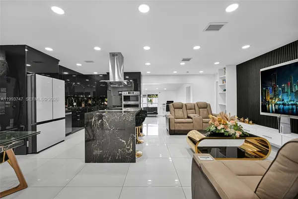 a living room with furniture a rug and a flat screen tv