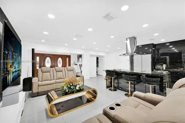 a kitchen with lots of counter top space and living room view