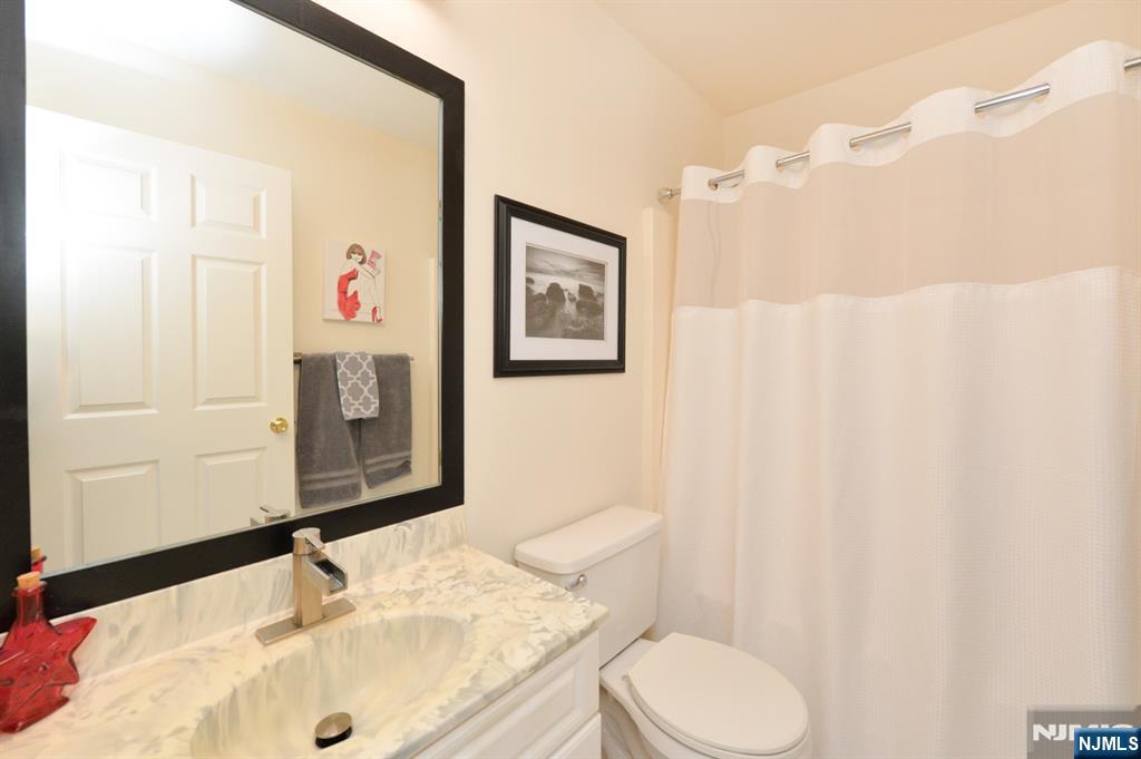 20 Parkside Court Wayne, NJ 07470 - Photo 12 of 22 a bathroom with a sink and a mirror