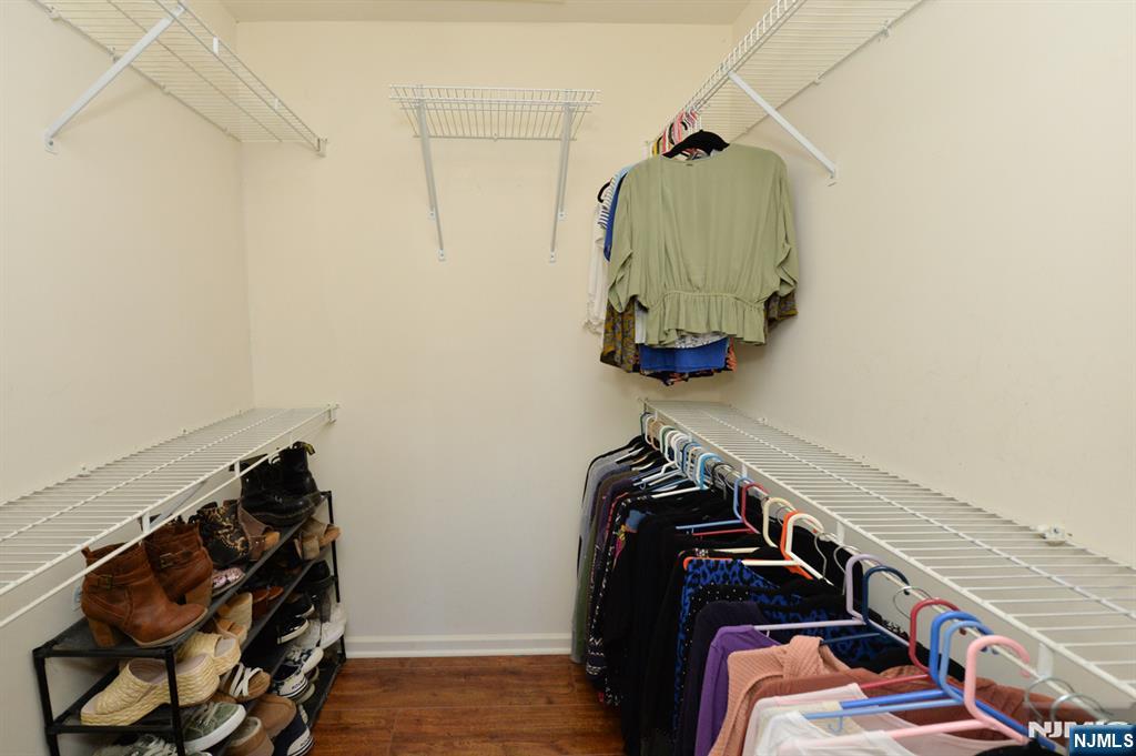 20 Parkside Court Wayne, NJ 07470 - Photo 14 of 22 a view of walk in closet with clothes and shoes