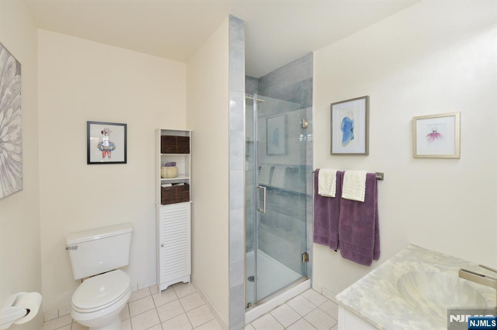 20 Parkside Court Wayne, NJ 07470 - Photo 15 of 22 a bathroom with a toilet sink and shower