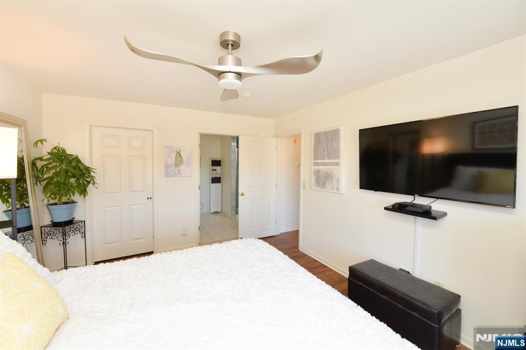 20 Parkside Court Wayne, NJ 07470 - Photo 16 of 22 a bedroom with a bed and a flat screen tv