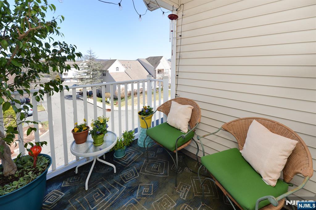 20 Parkside Court Wayne, NJ 07470 - Photo 5 of 22 an outdoor sitting area with furniture and a potted plant