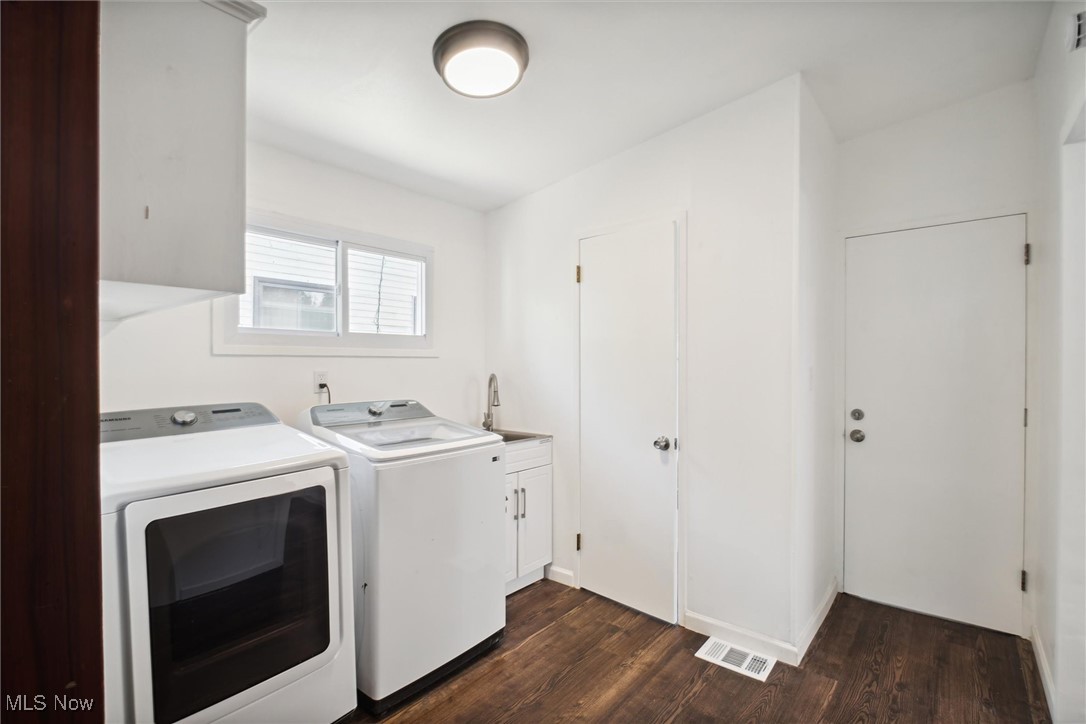 6683 Sherborn Road Cleveland, OH 44130 - Photo 17 of 42 Laundry room featuring sink, washing machine and dryer, cabinets, and dark wood-type flooring