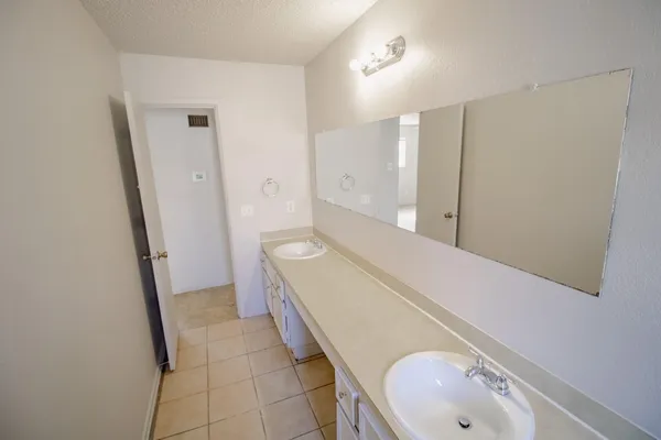 a bathroom with a sink a toilet and a shower