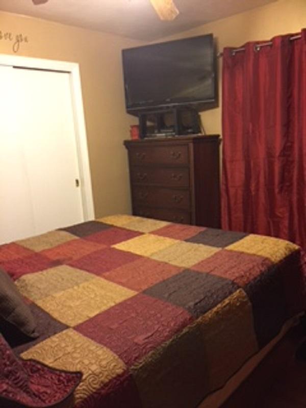 2046 Routt Road Northwest Roanoke, VA 24017 - Photo 8 of 26 a bedroom with a bed and wooden cabinets