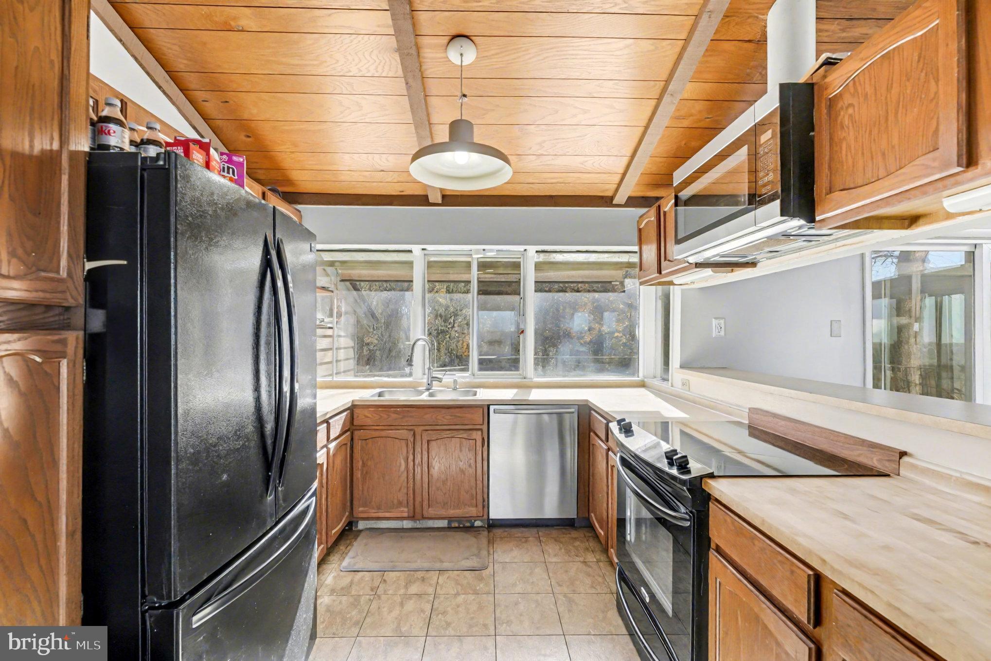 16031 Arthur Road King George, VA 22485 - Photo 12 of 26 a kitchen with stainless steel appliances granite countertop a sink and a refrigerator