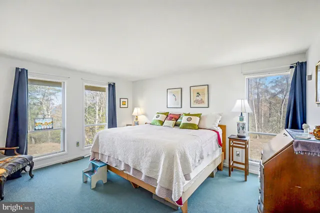 a bedroom with a bed and glass window