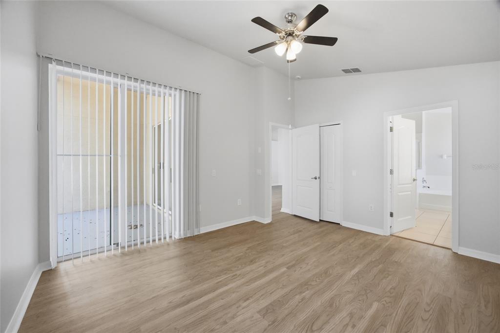 13323 Bainbridge Way Spring Hill, FL 34609 - Photo 12 of 33 an empty room with fan and windows