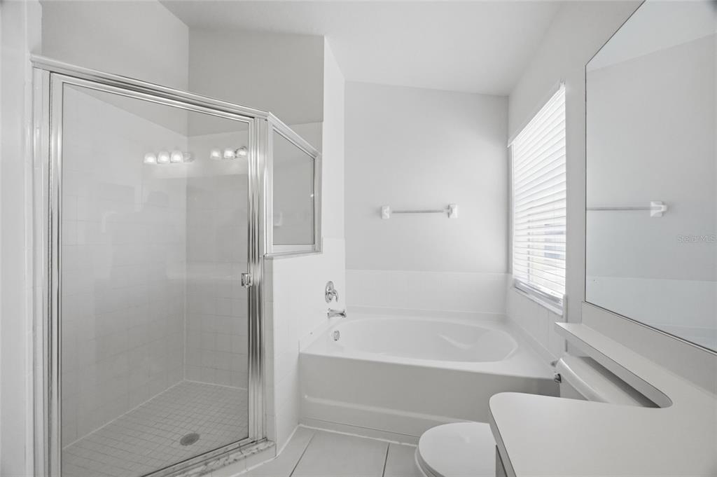 13323 Bainbridge Way Spring Hill, FL 34609 - Photo 13 of 33 a bathroom with a tub and shower