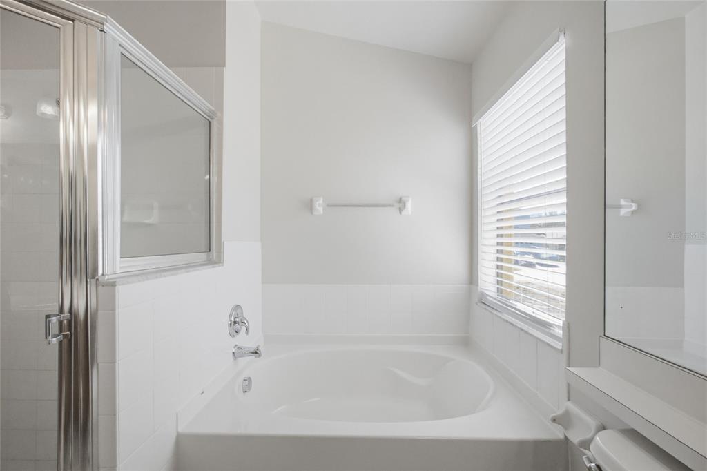 13323 Bainbridge Way Spring Hill, FL 34609 - Photo 14 of 33 a white bath tub sitting next to a window