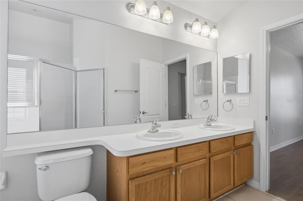 13323 Bainbridge Way Spring Hill, FL 34609 - Photo 15 of 33 a bathroom with a sink double vanity and a mirror