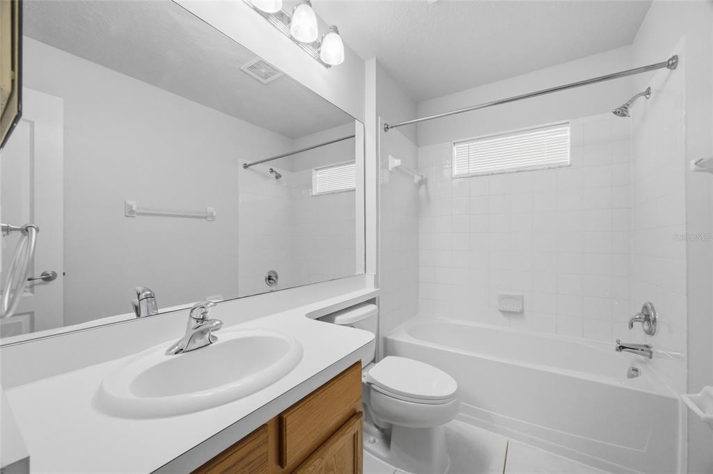 13323 Bainbridge Way Spring Hill, FL 34609 - Photo 18 of 33 a bathroom with a sink a toilet and shower