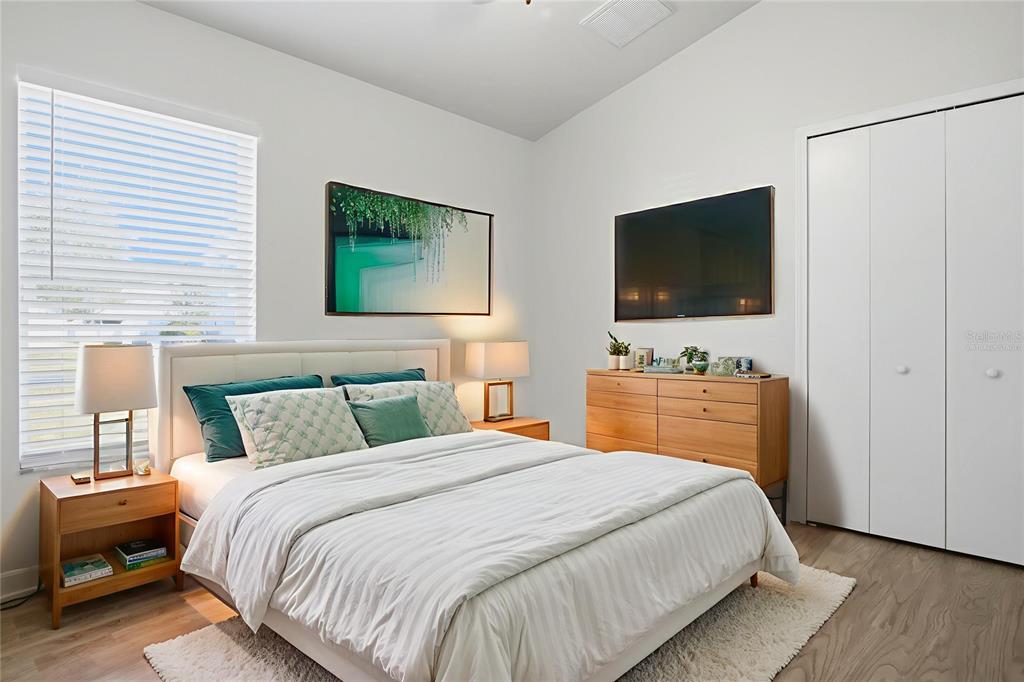 13323 Bainbridge Way Spring Hill, FL 34609 - Photo 19 of 33 a bedroom with a bed and a flat screen tv