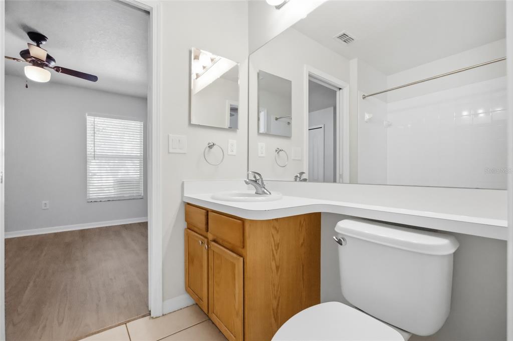 13323 Bainbridge Way Spring Hill, FL 34609 - Photo 21 of 33 a bathroom with a sink toilet a mirror and vanity