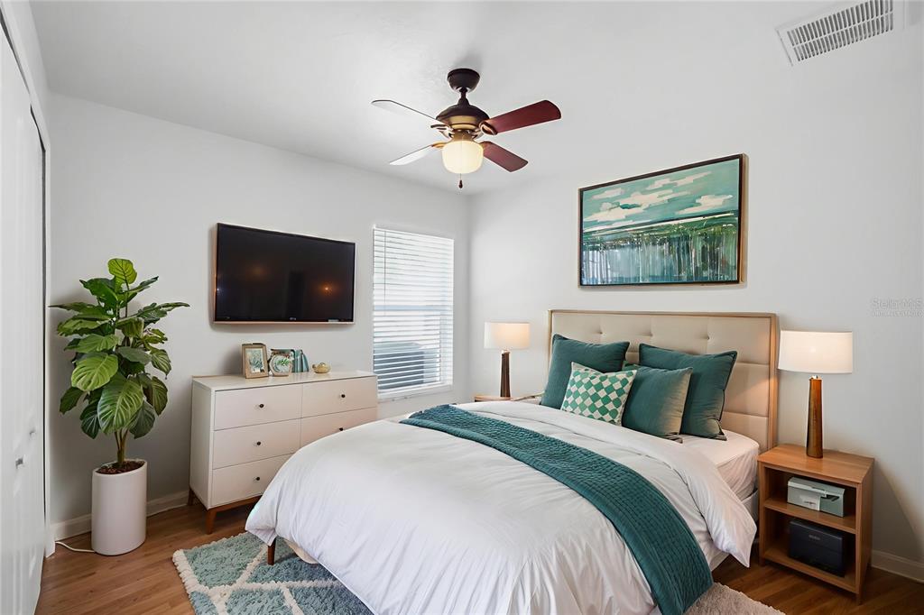 13323 Bainbridge Way Spring Hill, FL 34609 - Photo 23 of 33 a bedroom with a bed and a flat screen tv