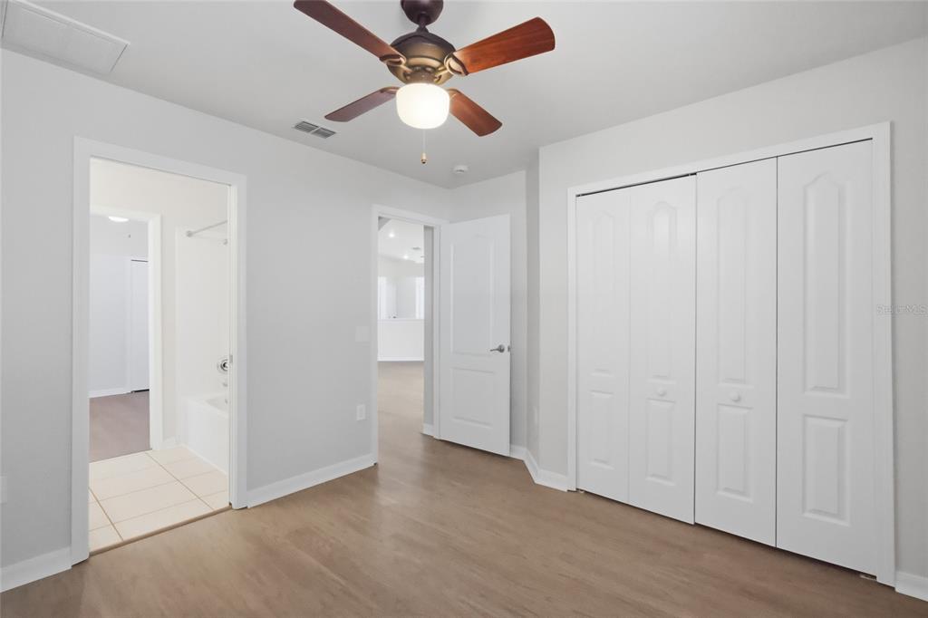 13323 Bainbridge Way Spring Hill, FL 34609 - Photo 24 of 33 an empty room with fan and a ceiling fan