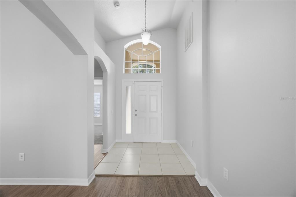13323 Bainbridge Way Spring Hill, FL 34609 - Photo 3 of 33 a view of entryway with wooden floor
