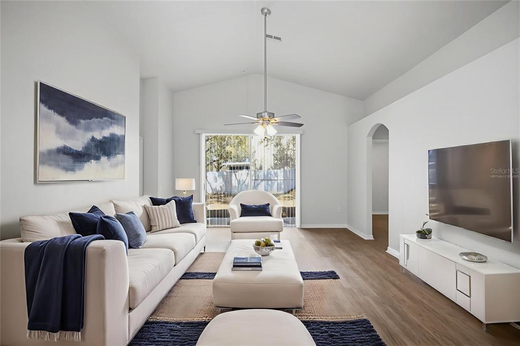 13323 Bainbridge Way Spring Hill, FL 34609 - Photo 10 of 33 a living room with furniture and a flat screen tv