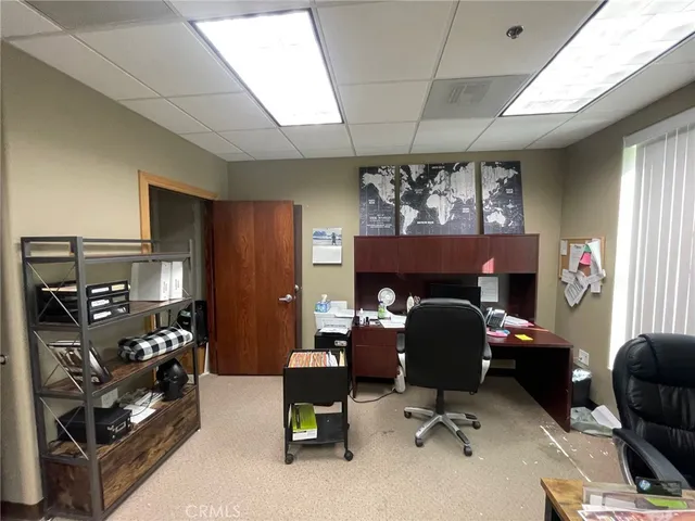a kitchen with a dining table chairs and sink