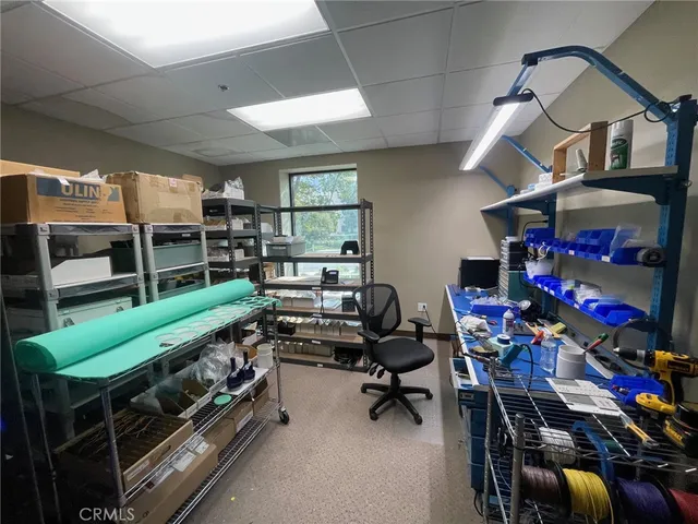 a kitchen with a table chairs refrigerator and cabinets