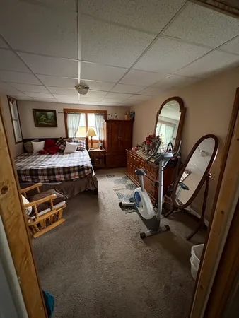 a bedroom with furniture and a window