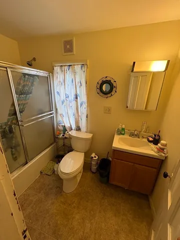 a view of a field with trees in the background