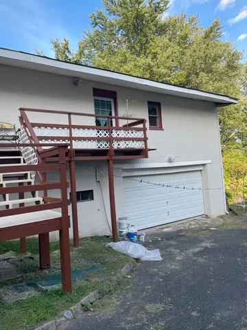 a view of a house with truck parked on the road