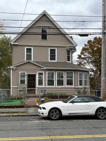a front view of a house with parking space