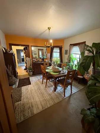 a living room with furniture a fireplace and a large window