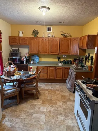 a kitchen with stainless steel appliances a stove a sink and a refrigerator