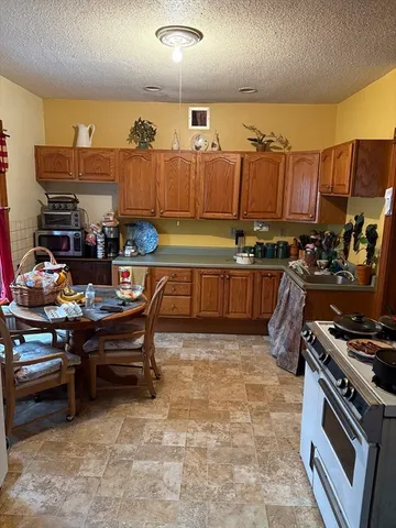 a kitchen with stainless steel appliances a stove a sink and a refrigerator