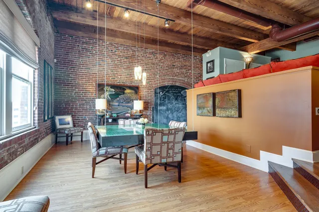a dining room with wooden floor and window