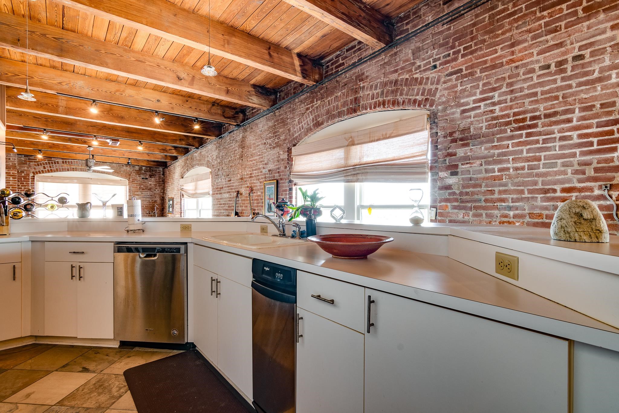 262 Wagner Place, Unit 402 Memphis, TN 38103 - Photo 9 of 40 a kitchen with a sink cabinets stainless steel appliances and a counter top space