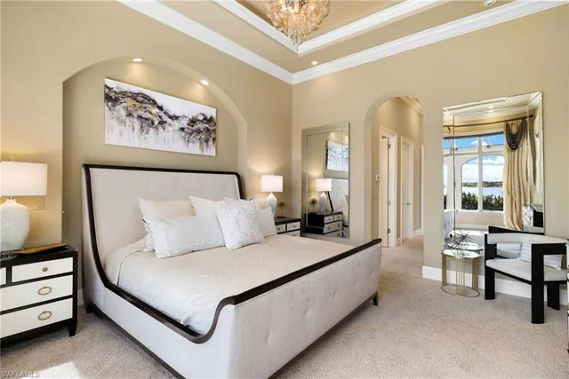 a bedroom with furniture and large windows