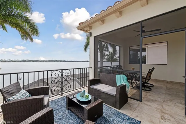 a living room with furniture a chandelier and a fireplace
