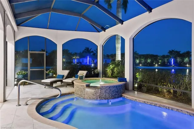 a view of hall way with furniture and chandelier