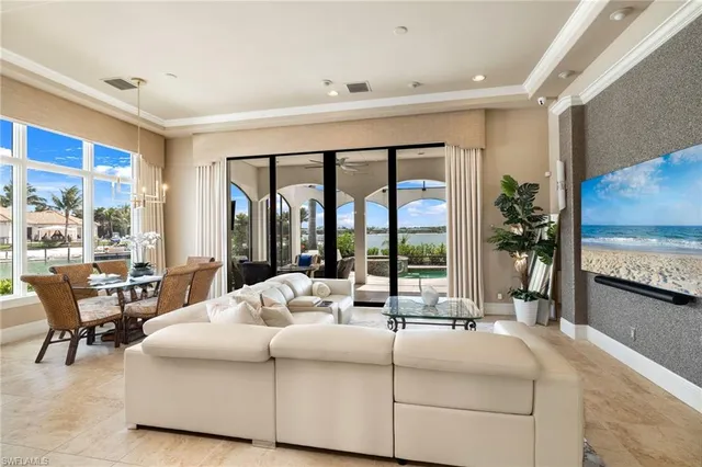 a bedroom with a bed and large windows