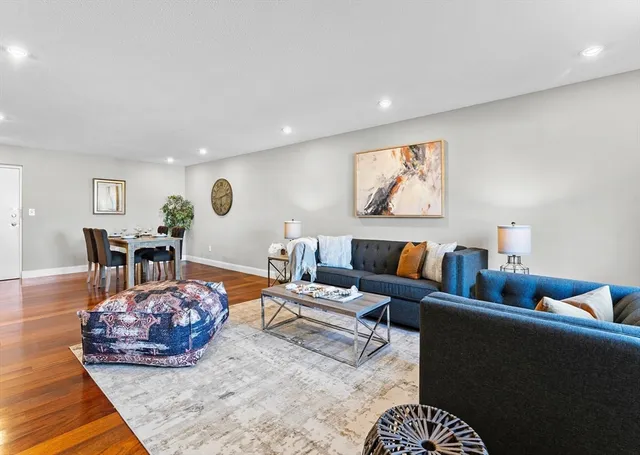 a living room with furniture and wooden floor
