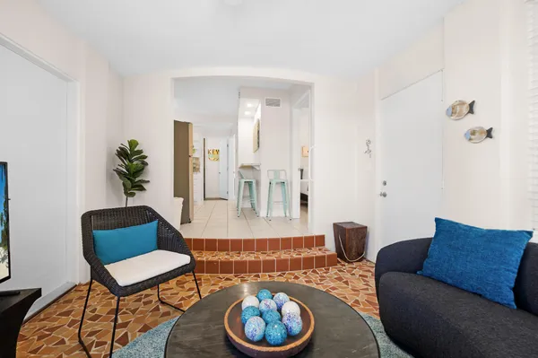 a living room with furniture a rug and a large window